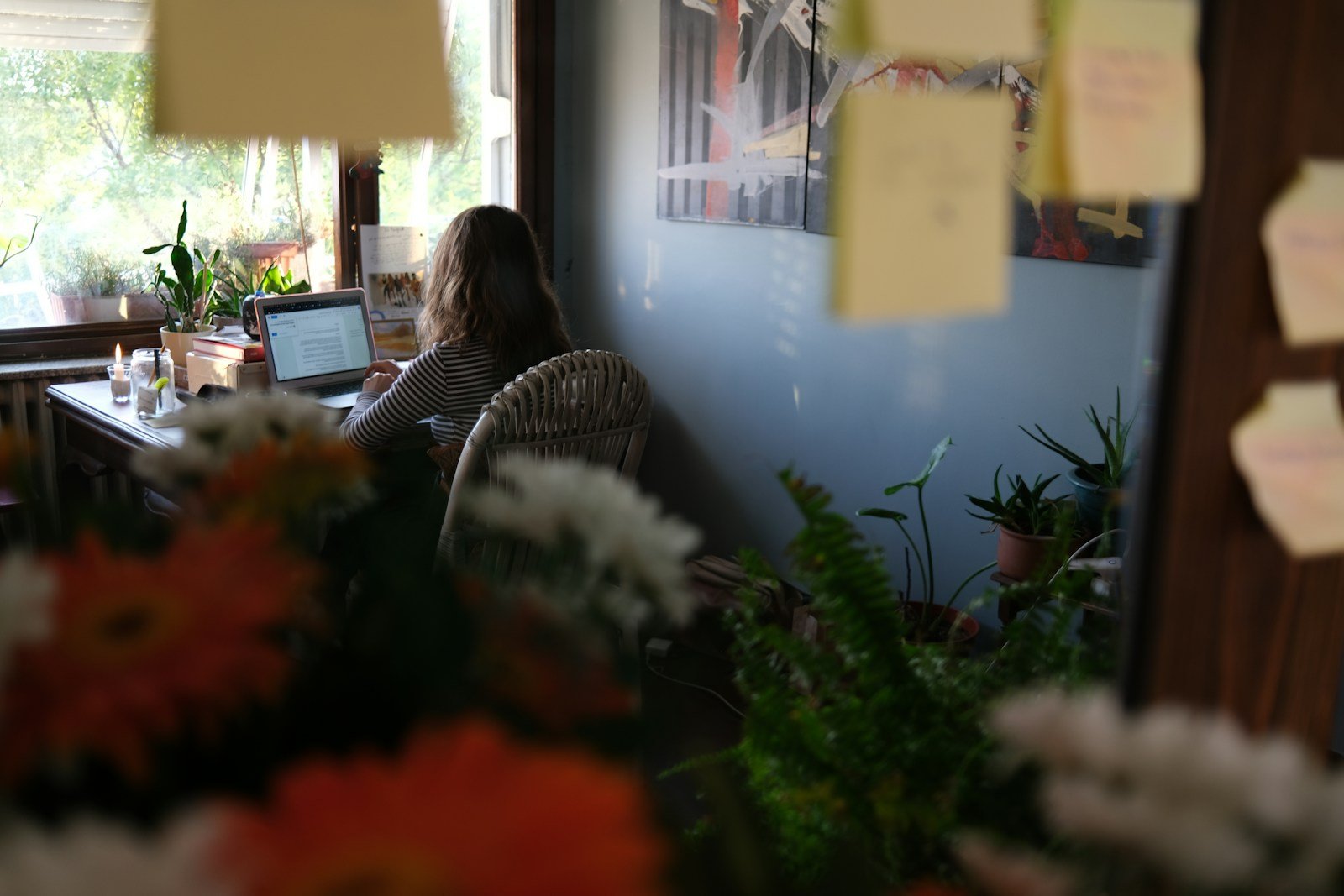 Creative designer working at a laptop in a warm modern workspace