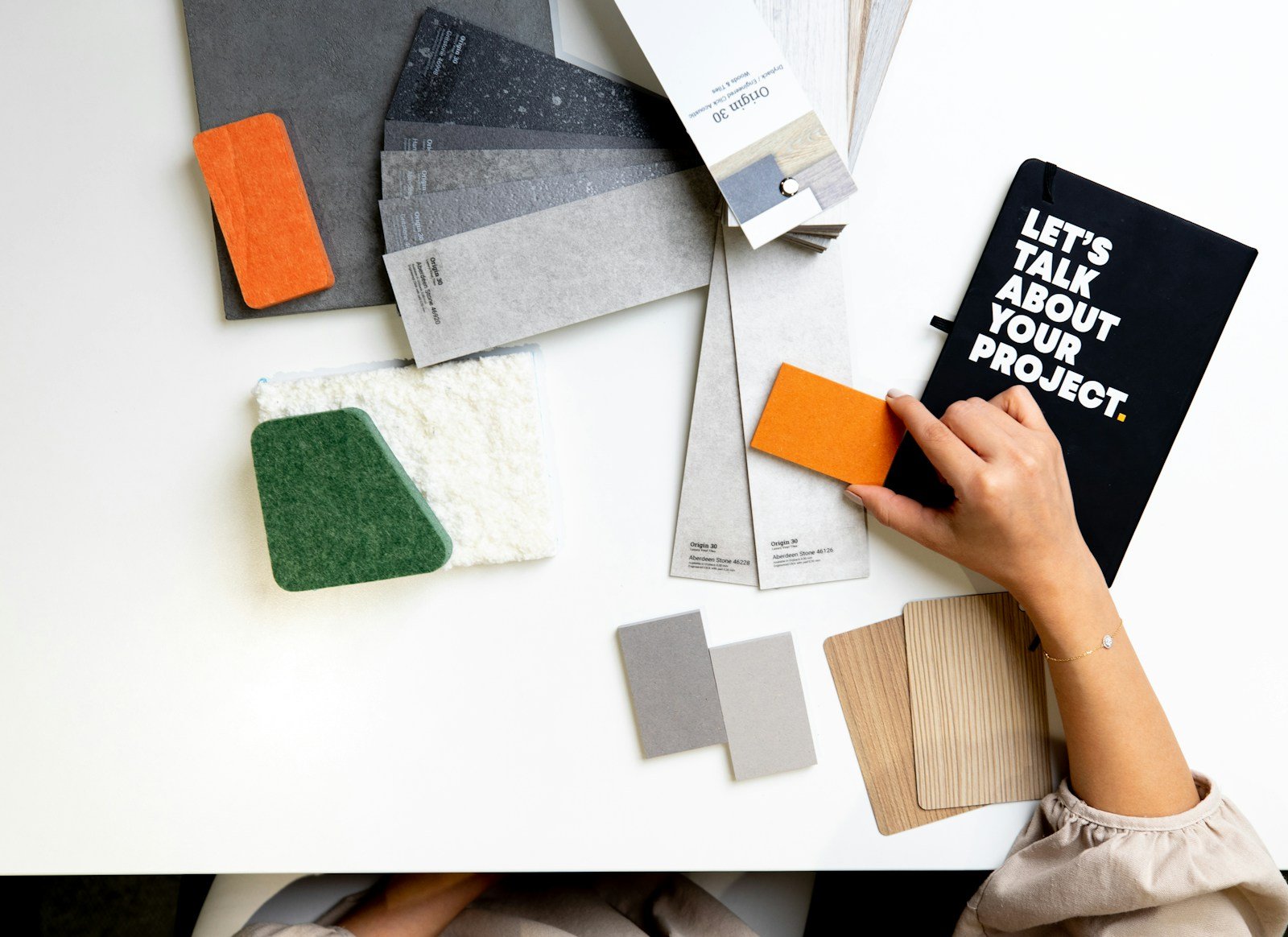 Designer hands working with material and color samples