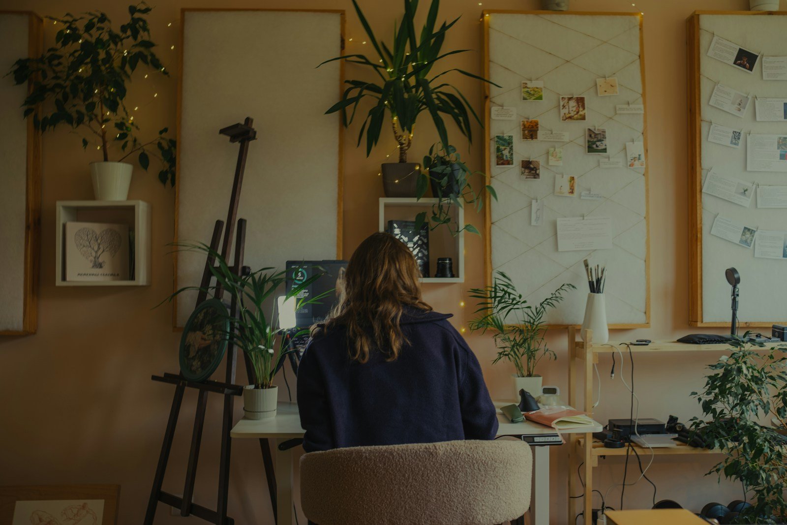 Creative professional working in a plant-filled studio
