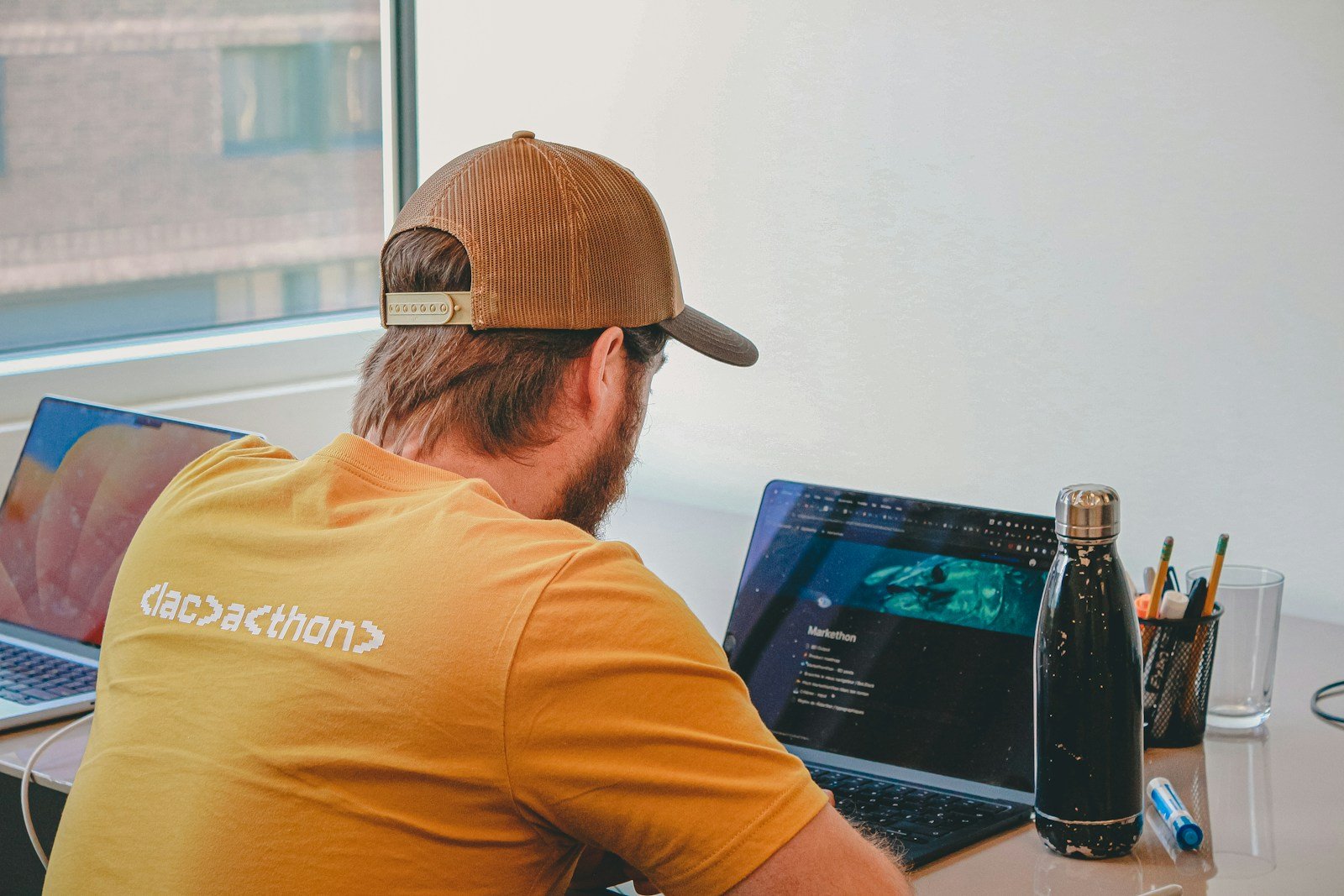 Developer working on laptops in a modern workspace