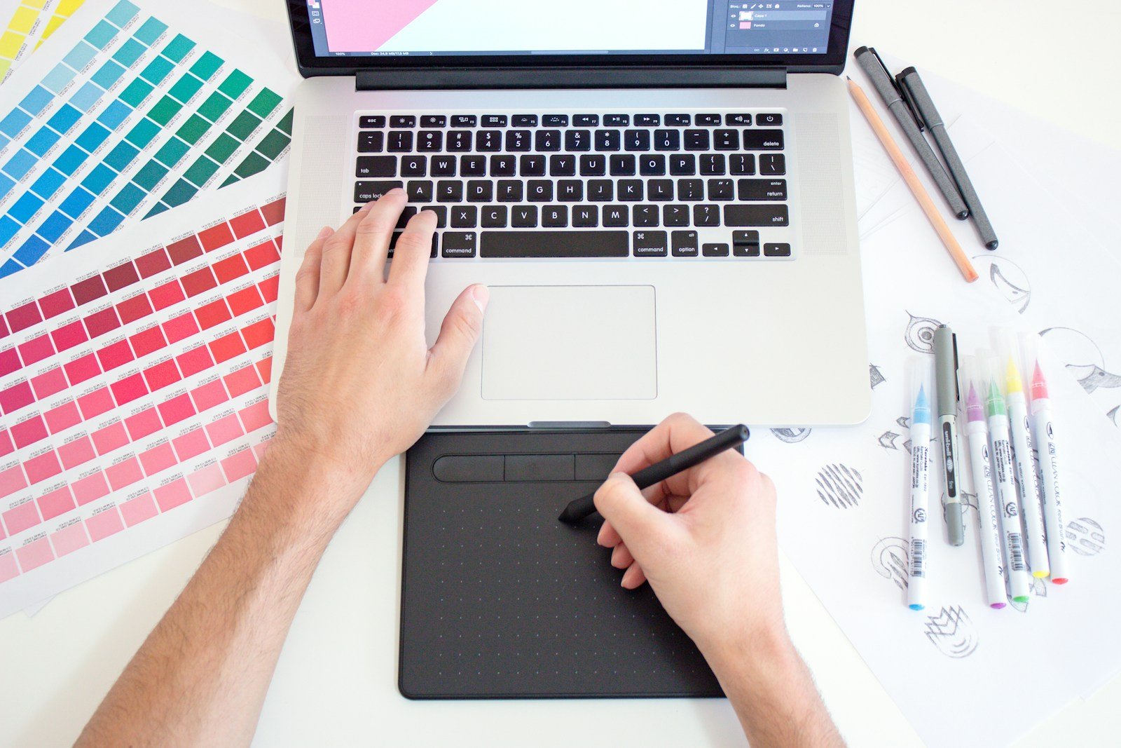 Graphic designer working with color charts and branding materials