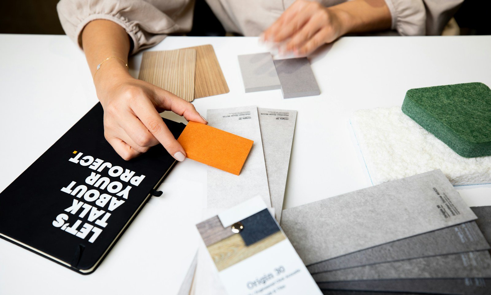 Designer writing and sketching ideas on paper