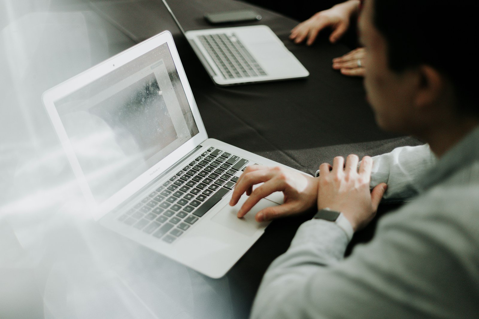 Person working on a laptop in a modern workspace